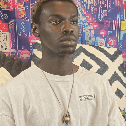 Model wearing Golden Warrior Helmet Gaming Necklace with detailed gold helmet charm on a gold chain.