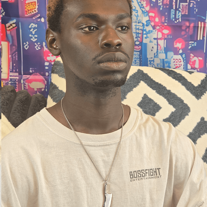 Model wearing Hatchet Anime Necklace with silver metal hatchet charm on a silver chain.