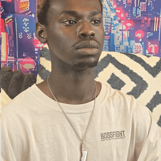 Model wearing Hatchet Anime Necklace with silver metal hatchet charm on a silver chain.